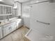 Bathroom featuring a walk-in shower, white vanity, medicine cabinet, and tile flooring at 2823 Edsel Pl, Charlotte, NC 28205