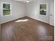 Empty bedroom featuring hardwood floors, two windows and a ceiling fan at 2823 Edsel Pl, Charlotte, NC 28205