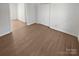 A view of an empty bedroom with wood floors, white walls, and a double closet at 2823 Edsel Pl, Charlotte, NC 28205