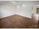 Spacious living room featuring hardwood flooring and recessed lighting with view to the entry of the kitchen at 2823 Edsel Pl, Charlotte, NC 28205