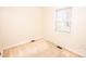 A bright, neutral bedroom with carpet flooring and natural lighting at 3309 E Broad St, Statesville, NC 28625