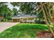 Charming home featuring a cozy front porch, carport, and lush green lawn at 3309 E Broad St, Statesville, NC 28625