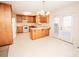 Well-lit eat-in kitchen featuring wooden cabinets, white appliances, and sliding doors to the deck at 3309 E Broad St, Statesville, NC 28625