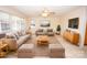 Bright living room features neutral walls, plush seating, a ceiling fan, and ample natural light at 3309 E Broad St, Statesville, NC 28625