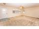 Spacious living room with neutral walls, carpet flooring, and a ceiling fan at 3309 E Broad St, Statesville, NC 28625