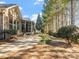 Spacious backyard with brick patio, screen porch, mature trees, and neatly manicured landscaping at 4104 Granite Cir, Indian Land, SC 29707