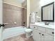 Neutral-toned bathroom with a shower-tub combo, decorative tile surround and vanity with framed mirror at 4104 Granite Cir, Indian Land, SC 29707