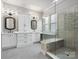 Modern bathroom featuring double sinks, tile flooring and a frameless glass shower with built-in bench at 4104 Granite Cir, Indian Land, SC 29707