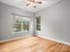 Spacious bedroom with hardwood floors, two large windows, and neutral walls at 4104 Granite Cir, Indian Land, SC 29707