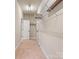 Walk-in closet features wire shelving, beige walls, carpet floors and a door leading to an adjacent room at 4104 Granite Cir, Indian Land, SC 29707