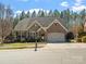 Charming single-Gathering home featuring a brick and stone facade, two-car garage, and manicured landscaping at 4104 Granite Cir, Indian Land, SC 29707