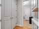 Bright hallway with closet, white cabinets, and tile floors leading to the front door at 4104 Granite Cir, Indian Land, SC 29707