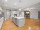 Open-concept kitchen leading to a cozy living room with a stone fireplace and TV at 4104 Granite Cir, Indian Land, SC 29707