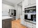 Modern kitchen with stainless steel appliances, white cabinets, and a large island with counter seating at 4104 Granite Cir, Indian Land, SC 29707