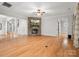 Bright living room featuring a stone fireplace, hardwood floors, and an open layout at 4104 Granite Cir, Indian Land, SC 29707