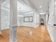 Open-concept living room with hardwood floors, columns, and elegant lighting fixtures at 4104 Granite Cir, Indian Land, SC 29707