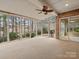 Bright sunroom with brick wall, ceiling fan, and wall to wall windows with wooded view at 4104 Granite Cir, Indian Land, SC 29707