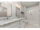 Bathroom with double vanity, marble countertop, and a bathtub at 419 Sylvania Ave, Charlotte, NC 28206