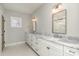 Double vanity bathroom with marble countertops and large mirror at 419 Sylvania Ave, Charlotte, NC 28206