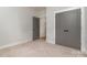 Bright bedroom with carpet flooring and double doors leading to the closet at 419 Sylvania Ave, Charlotte, NC 28206