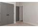 Bedroom with gray doors and neutral walls, showcasing closet and additional door at 419 Sylvania Ave, Charlotte, NC 28206