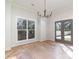 Elegant dining room with hardwood floors, french doors, and chandelier at 419 Sylvania Ave, Charlotte, NC 28206