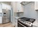 Modern kitchen with stainless steel appliances and gray tile backsplash at 419 Sylvania Ave, Charlotte, NC 28206