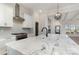 Bright kitchen with white cabinets, marble countertops, and a stylish range hood at 419 Sylvania Ave, Charlotte, NC 28206