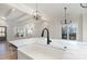 Modern kitchen with marble countertops, farmhouse sink, and black faucet at 419 Sylvania Ave, Charlotte, NC 28206