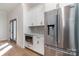 Kitchen boasts stainless steel appliances and white cabinets at 419 Sylvania Ave, Charlotte, NC 28206