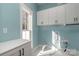 Laundry room with white cabinets and light blue walls at 419 Sylvania Ave, Charlotte, NC 28206