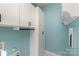 Laundry room featuring white cabinets and a light blue color scheme at 419 Sylvania Ave, Charlotte, NC 28206