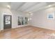 Light-filled living room featuring hardwood floors and a stylish front door at 419 Sylvania Ave, Charlotte, NC 28206