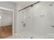 Large walk-in shower with glass enclosure and white tile at 419 Sylvania Ave, Charlotte, NC 28206