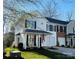 Two-story townhome with white siding, black shutters, and a small front porch at 711 Torrey Pines Ln, Fort Mill, SC 29715