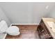 Small powder room with dark vanity and wood-look tile floor at 711 Torrey Pines Ln, Fort Mill, SC 29715