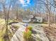 Single story home with a large driveway and American flag, nestled in a wooded area at 911 Wildwood Dr, Kings Mountain, NC 28086