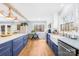 Renovated kitchen with blue cabinets, a farmhouse sink, and granite countertops at 911 Wildwood Dr, Kings Mountain, NC 28086