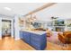 Open kitchen with island and blue cabinets, view to living room and fireplace at 911 Wildwood Dr, Kings Mountain, NC 28086