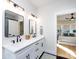 Modern bathroom with double vanity, black accents, and view into bedroom at 1019 Trembeth Dr, Charlotte, NC 28205