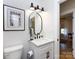 Modern bathroom with white vanity, oval mirror, and black accents at 1019 Trembeth Dr, Charlotte, NC 28205