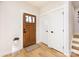 Light-filled entryway with wood floors, a coat closet, and a wooden door at 1019 Trembeth Dr, Charlotte, NC 28205