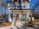 Two-story house with gray and white siding, a front porch, and a landscaped yard at 1019 Trembeth Dr, Charlotte, NC 28205