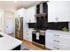 Modern kitchen with stainless steel appliances and dark-colored tile backsplash at 1019 Trembeth Dr, Charlotte, NC 28205