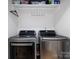 Laundry room with LG washer and dryer, overhead shelving, and hanging rod at 1019 Trembeth Dr, Charlotte, NC 28205