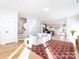 Bright living room with hardwood floors and a view into the kitchen and dining area at 1019 Trembeth Dr, Charlotte, NC 28205