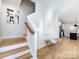 Modern staircase with light wood treads and white risers, leading to upper level at 1019 Trembeth Dr, Charlotte, NC 28205