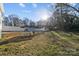 Expansive backyard featuring a chicken coop and a shed with a privacy fence and some trees at 110 College St, Marshville, NC 28103