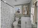 Bathroom features a floral shower curtain, a large mirror, and vintage style at 110 College St, Marshville, NC 28103