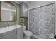 Renovated bathroom featuring a vanity with storage and a tiled shower at 110 College St, Marshville, NC 28103